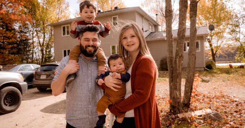 Smiling family of four enjoying a sunny autumn day in their backyard.